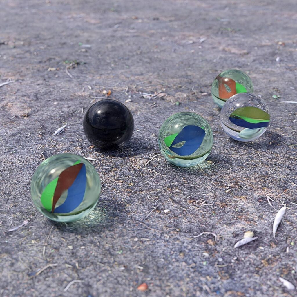 3D render of glass marbles on gravel