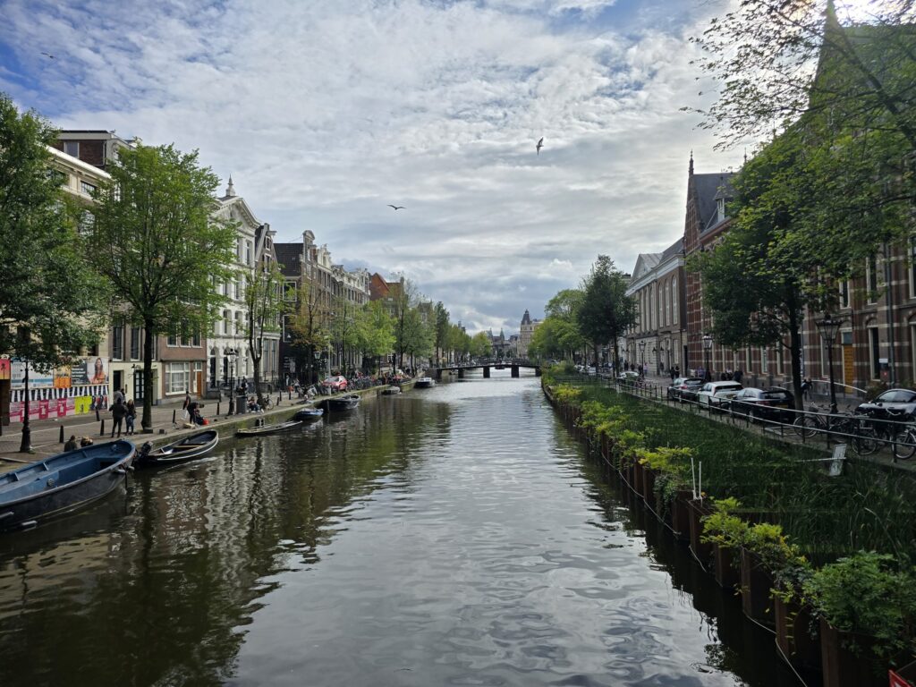 A quiet canal under a cloudy sky