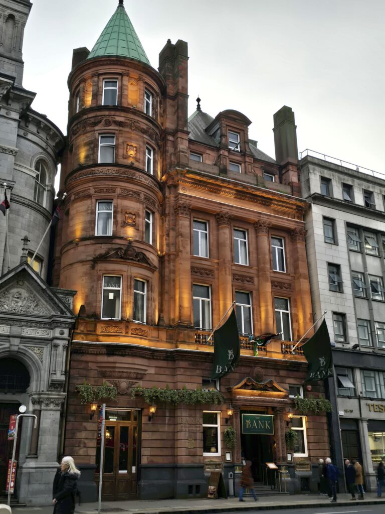 A red-brick corner building with a copper turret