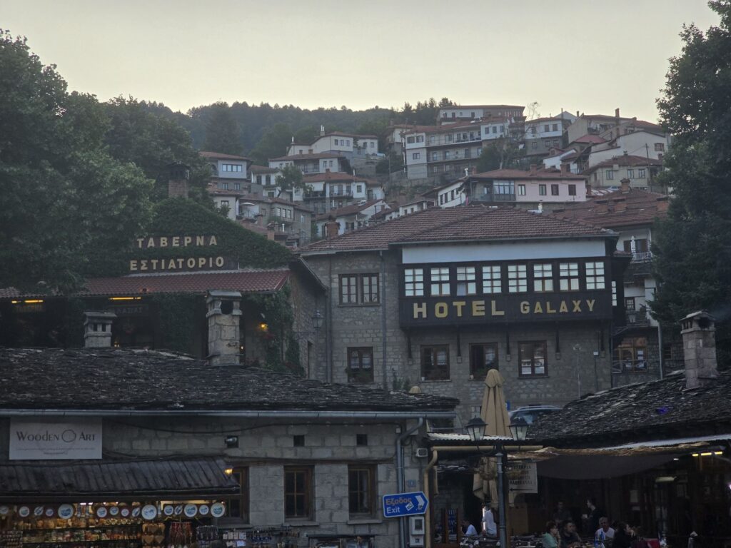 Evening on the square, with houses climbing the hillside
